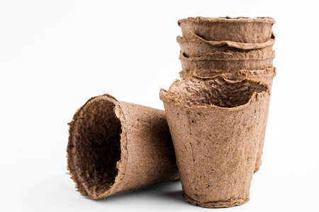 Pots for seedlings of ecological cardboard. Peat seed pots. Pots on isolated white backgroundの写真素材