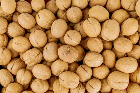 Raw walnuts, close-up, background with walnuts