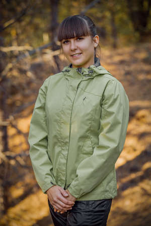 beatiful girl picking mushrooms in the autumn forest.