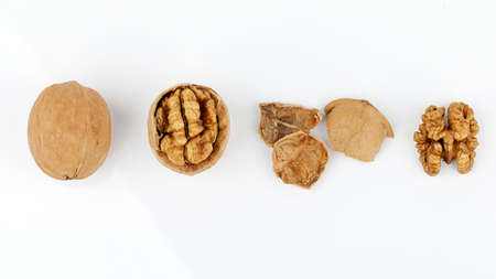 some cracked walnuts isolated on white background.