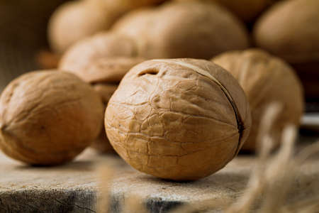 some raw walnuts on cutting board.