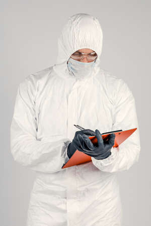 Doctor b fills out the forms. A man in a uniform and a face mask conducts, records the results....