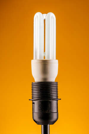 lamp on a yellow background. The concept of electricity