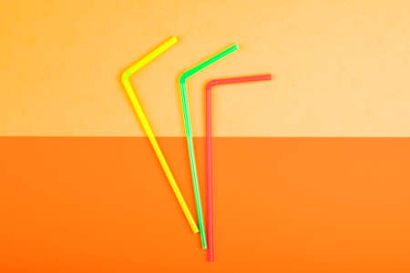 Drinking straws for colored background. Colorful plastic straws used for drinking water or soft drinksの写真素材