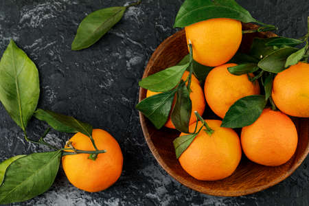 a plate with some tangerines on marble background.