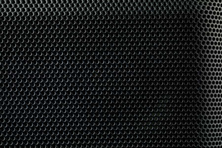 Metallic background with perforation of round holes. Black metal texture with round holes.の写真素材