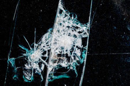 Cracks in car glass on a black backgroundの写真素材