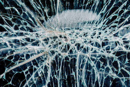 Cracks in car glass on a black background