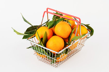 shop basket with some tangerines isolated on white background.の写真素材
