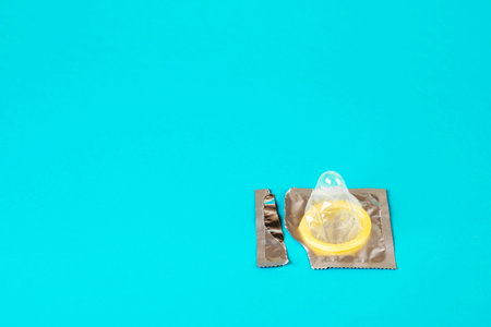 Condom on a blue background. The concept of safe sex