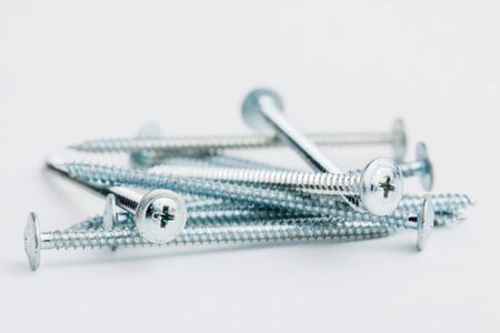 Stainless screws on white background.