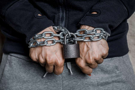 Women's hands in handcuffs, the concept of crime