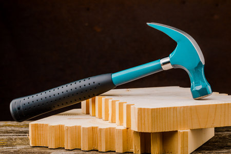 Blue hammer on a black background. The concept of construction and repair.