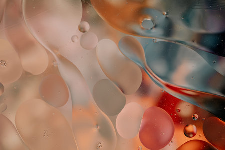 Close-up of the movement of oil droplets on the water surface. Colorful abstract macro background of...