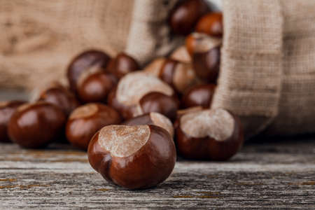Chestnuts on an old wooden table.