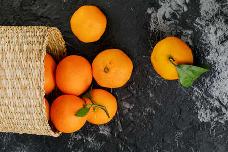 several tangerines in wicker basket on marble background.の写真素材
