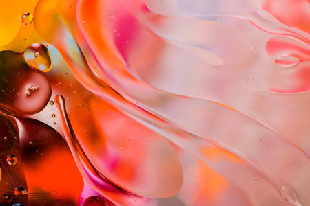 Close-up of the movement of oil droplets on the water surface. Colorful abstract macro background of...