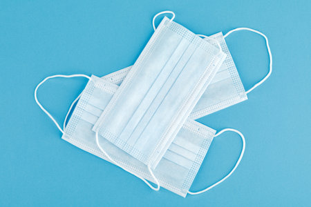 Medical mask, medical protective mask isolated on a blue background.の写真素材