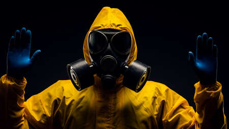 The concept of viral infection security. A man in a protective suit and gas mask.の写真素材