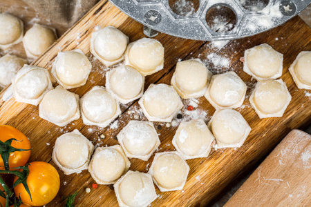 Cooking, cooking homemade ravioli, dumplings or meat dumplings on a wooden table. The view from the top.の写真素材
