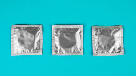 Condom on a blue background. The concept of safe sexの写真素材