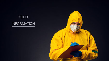 A scientist or medical professional in a protective suit on a black background records research in a...