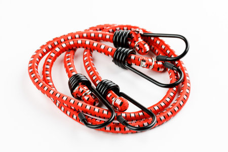 Elastic rubber rope with hook on the end on a white background.の写真素材