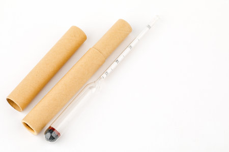 device for measuring the degree of alcohol in a distillery on a white background.