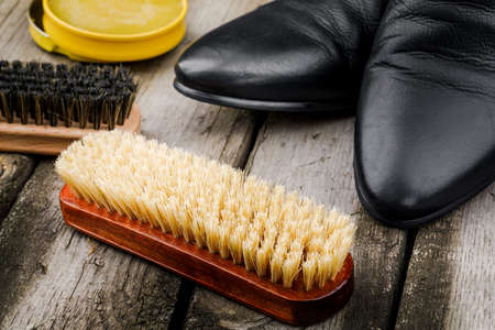 Accessories for the care and cleaning of shoes on a wooden table.の写真素材