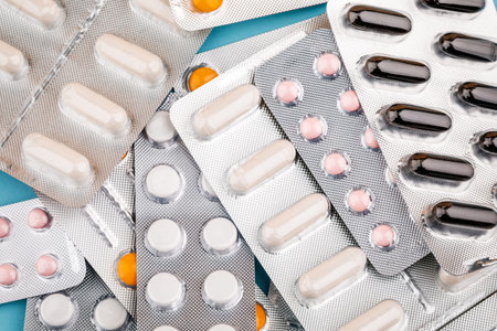 View of tablets in a blister, on a blue background