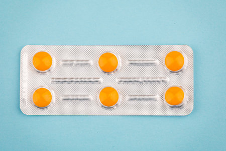 View of tablets in a blister, on a blue background