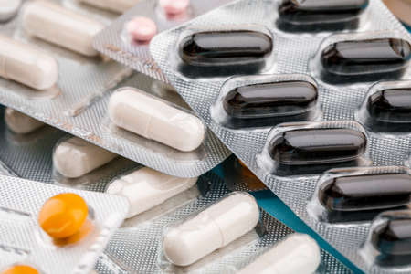 View of tablets in a blister, on a blue backgroundの写真素材