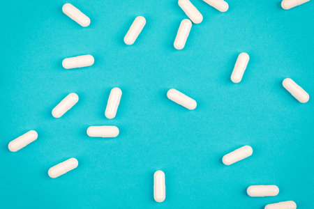 A bunch of pills on a blue background. The concept of healthcare.