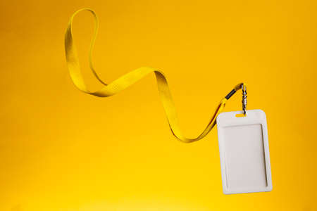 Badge for identification with the name and a yellow cord, empty space for textの写真素材
