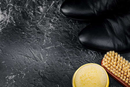 Shoe care and cleaning supplies on the black table.の写真素材
