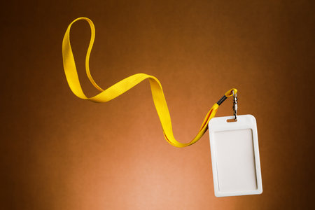 Badge for identification with the name and a yellow cord, empty space for textの写真素材