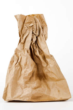 Crumpled paper bag with greasy spots on a white isolated background. Recycling of secondary waste.の写真素材