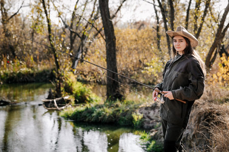 Woman fishing on the river. Fishing on a spinning rod.