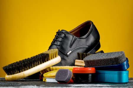 Accessories for the care and cleaning of shoes on a wooden table.の写真素材
