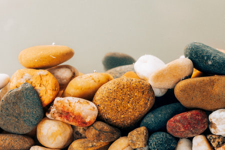 Colorful sea pebbles close-up. Background texture, sea stones in the water.の写真素材