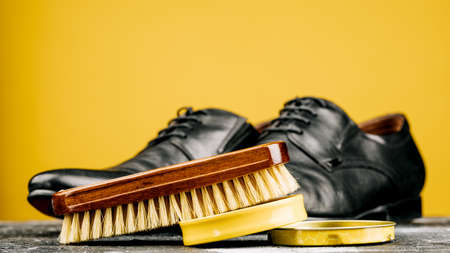 Accessories for the care and cleaning of shoes on a wooden table.の写真素材