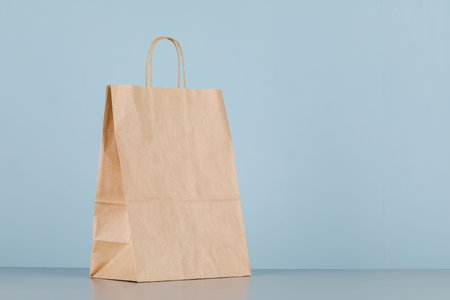 Brown paper bag with handles, empty shopping bag with area for your logo or design, food delivery...