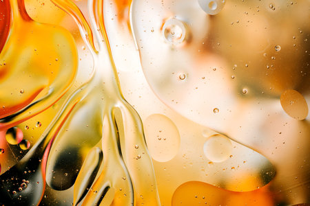 Close-up of the movement of oil droplets on the water surface. Colorful abstract macro background of...