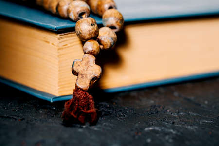 The Holy Bible on the dark table. Christian origin. The concept of faith, hope, and love.の写真素材