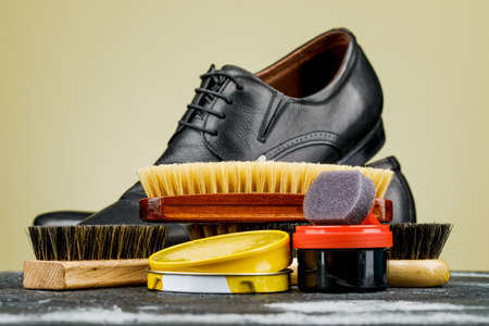 Accessories for the care and cleaning of shoes on a wooden table.の写真素材