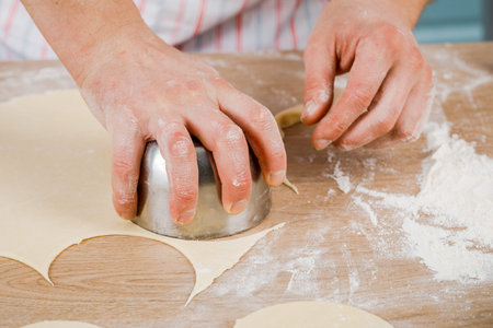 Smiling man kneads dough at home. The concept of baking. Copy space.の写真素材