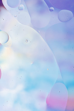 Close-up of the movement of oil droplets on the water surface. Colorful abstract macro background of oil drops on the water surfaceの写真素材