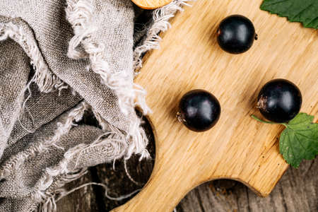 Fresh black currant. A handful of berries on a wooden table.の写真素材