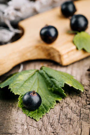 Fresh black currant. A handful of berries on a wooden table.の写真素材