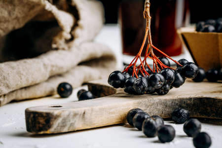 Fresh aronia berries and berry juice in a glassの写真素材